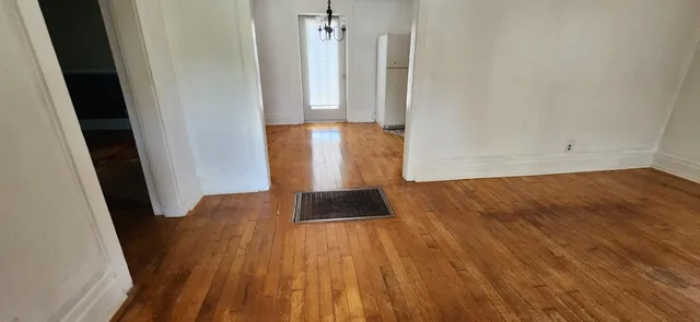 a view of a room with wooden floor and closet