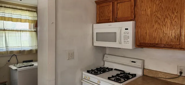 a kitchen with a stove and a microwave