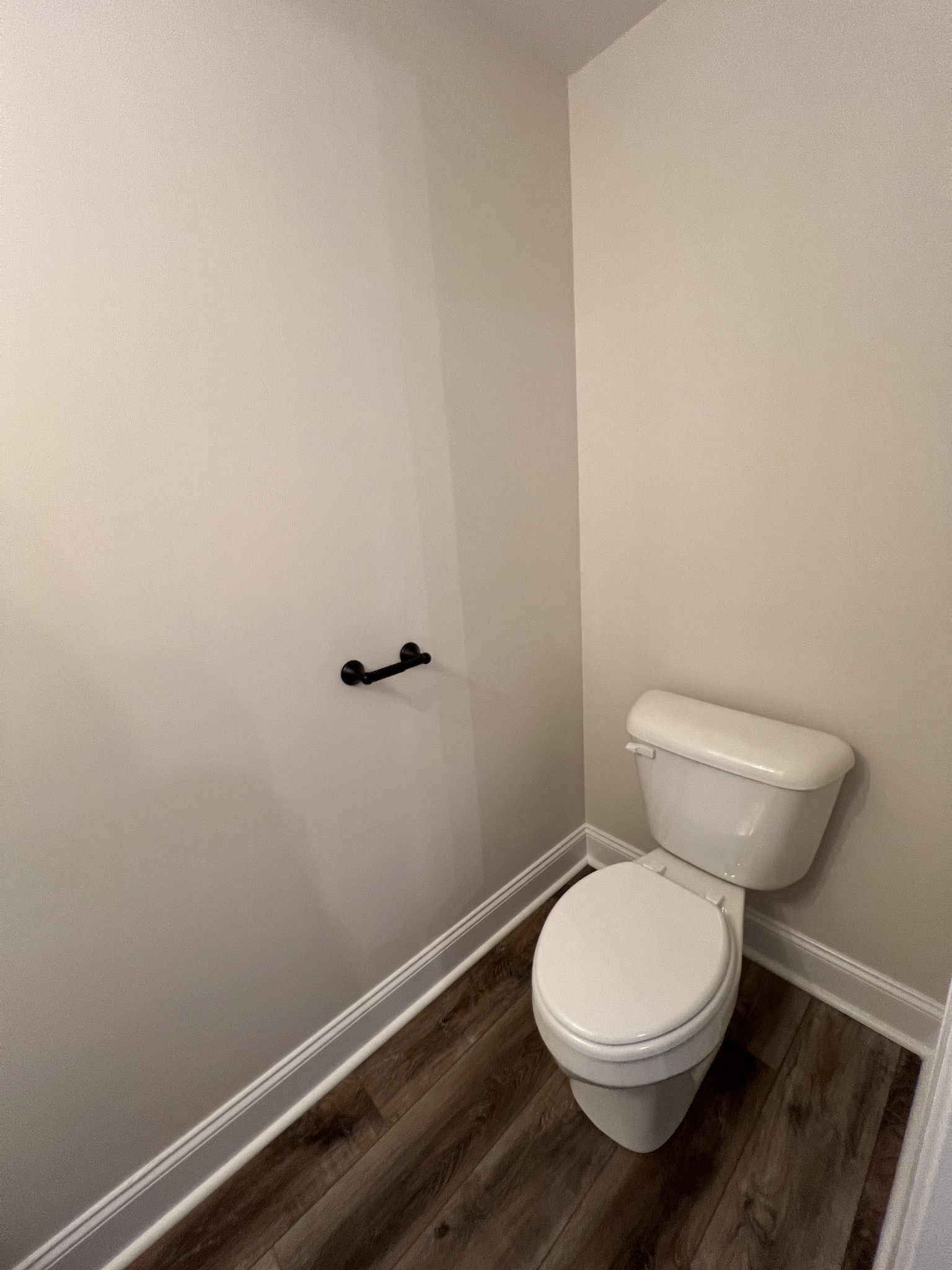 550 Peachers Mill Road, Unit B4 Clarksville, TN 37042 - Photo 11 of 34 a white toilet sitting next to a wooden cabinet
