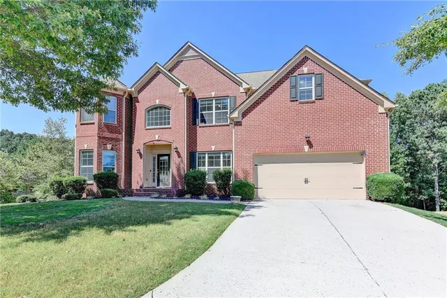 a front view of a house with a yard and garage