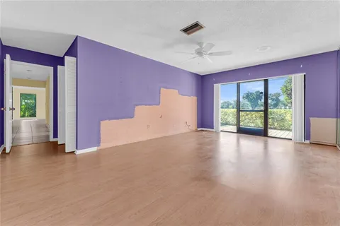 a view of a livingroom with a ceiling fan and window
