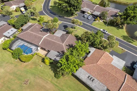 an aerial view of a house with a yard and lake view