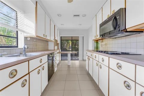 a kitchen with stainless steel appliances granite countertop a sink and a stove