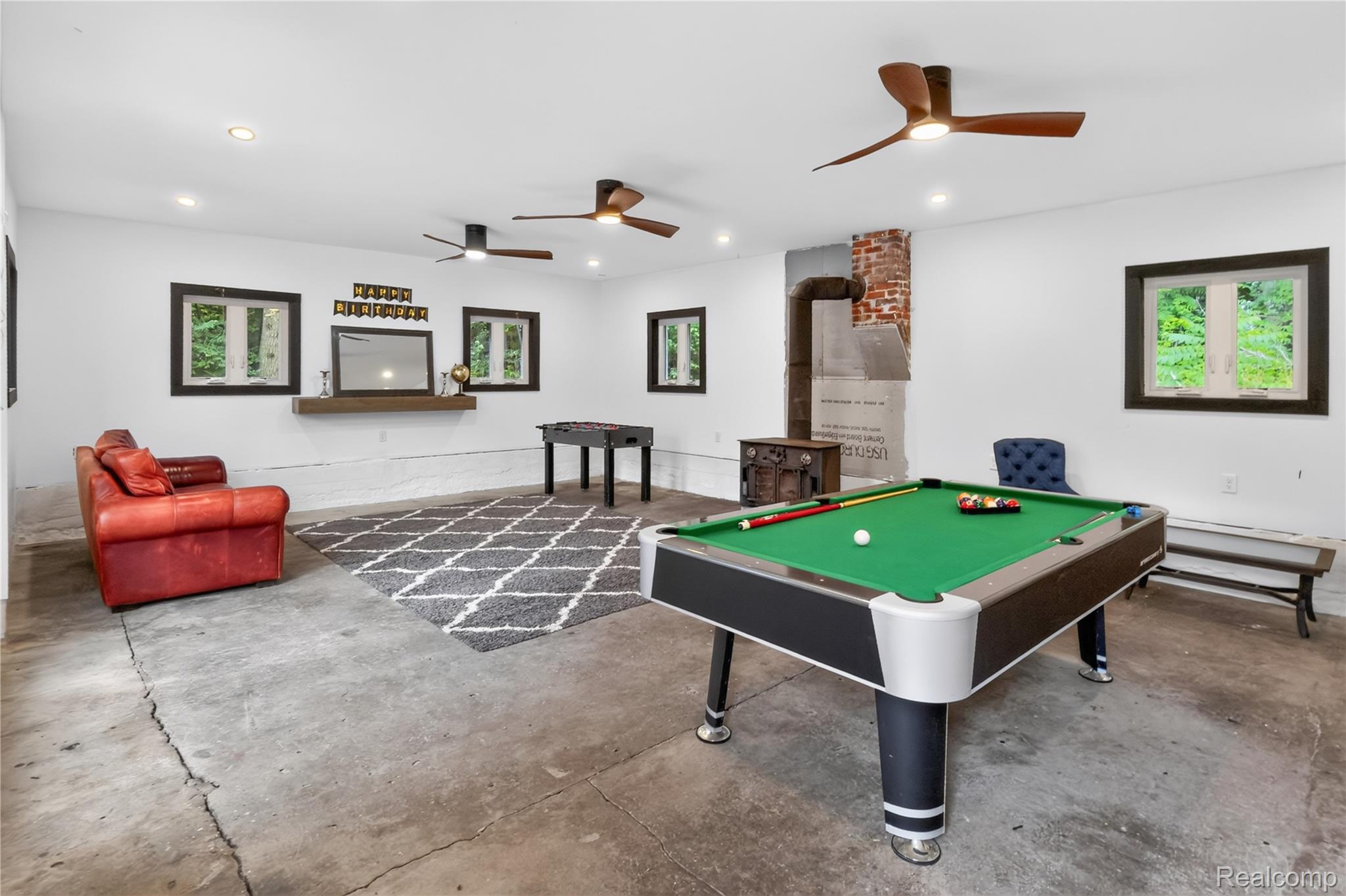 4860 Blue Bush Road Monroe, MI 48162 - Photo 38 of 59 Spacious room featuring concrete flooring and white walls, illuminated by recessed lighting and multiple ceiling fans