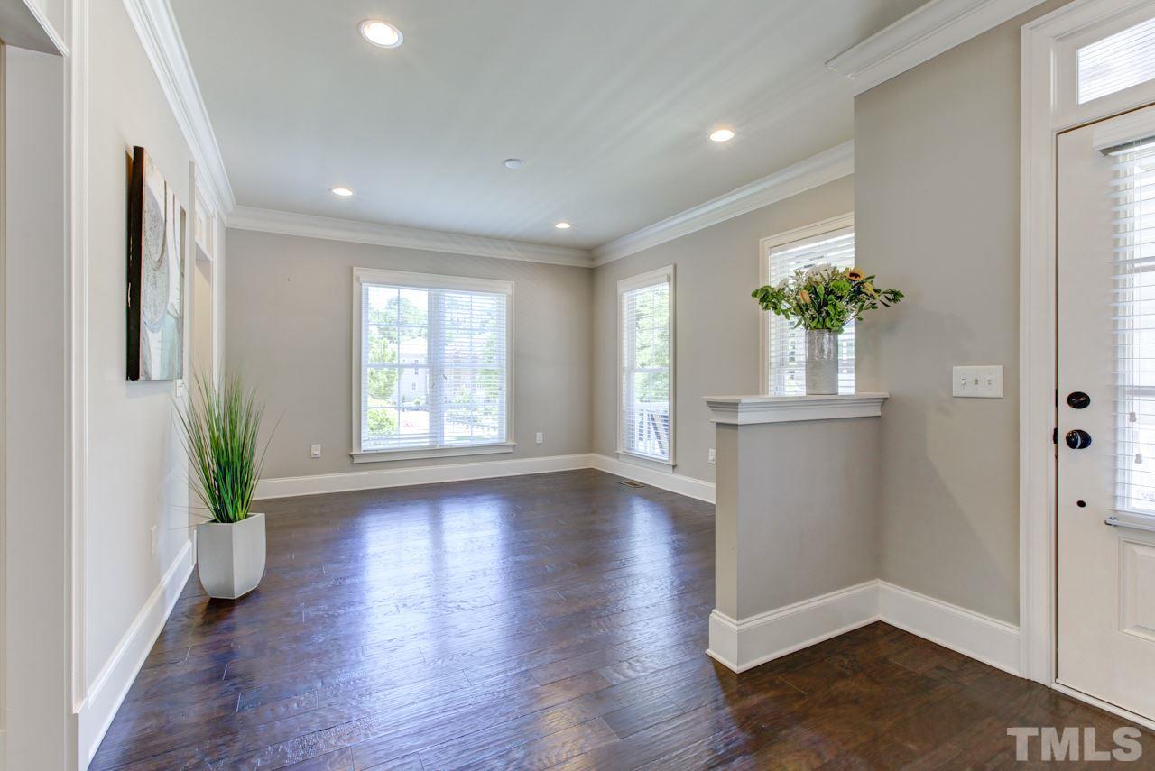 226 Penley Circle Raleigh, NC 27609 - Photo 6 of 14 a view of an empty room with a window and wooden floor
