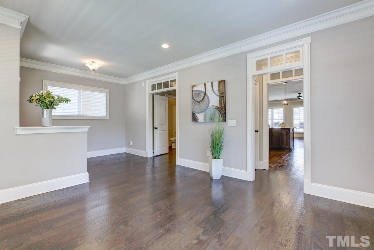 226 Penley Circle Raleigh, NC 27609 - Photo 7 of 14 a view of an empty room with wooden floor and a window
