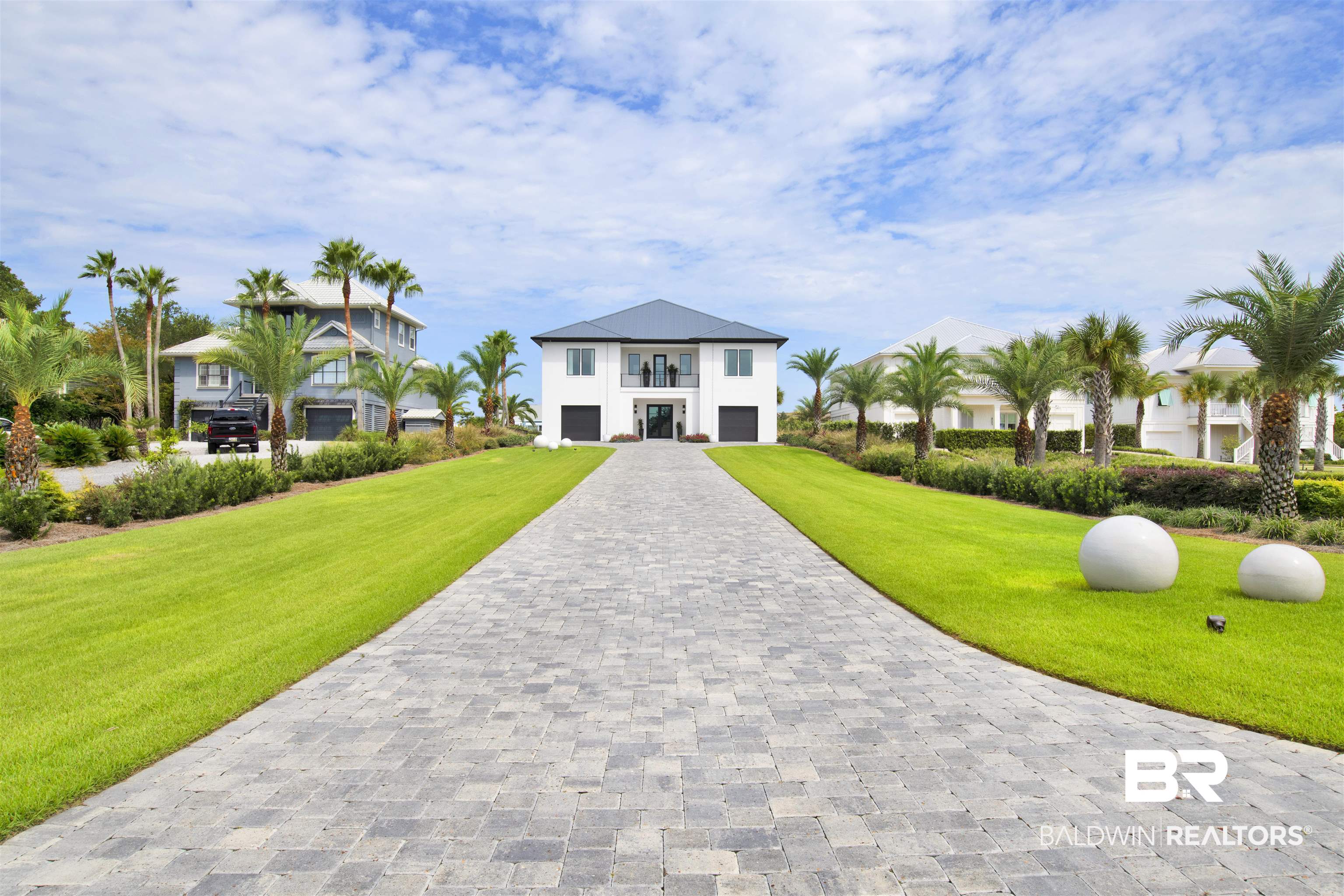 30239 Canal Court Orange Beach, AL 36561 - Photo 5 of 70 View of front of home featuring decorative driveway, a front yard, and a garage