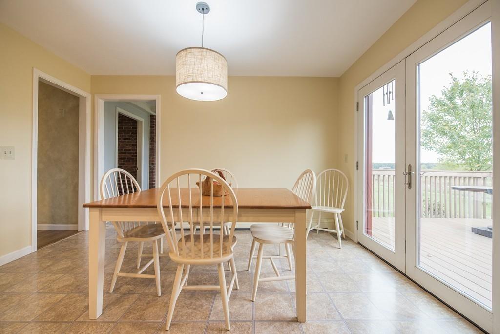 101 Plain Road Deerfield, MA 01373 - Photo 14 of 33 a view of a dining room with furniture wooden floor and chandelier
