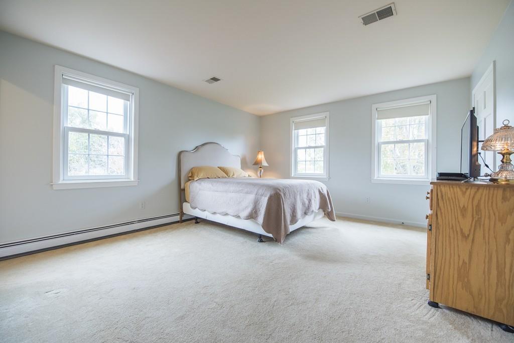 101 Plain Road Deerfield, MA 01373 - Photo 23 of 33 a spacious bedroom with a bed and wooden floor