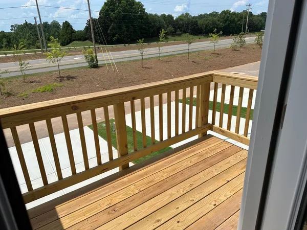 a view of balcony with wooden floor