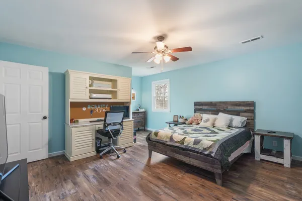 a bedroom with a bed and a table in it