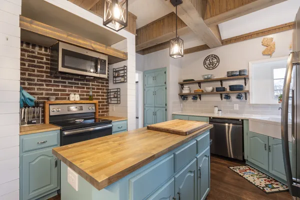 a kitchen with a stove and a refrigerator