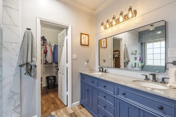 a spacious bathroom with a granite countertop sink mirror and double