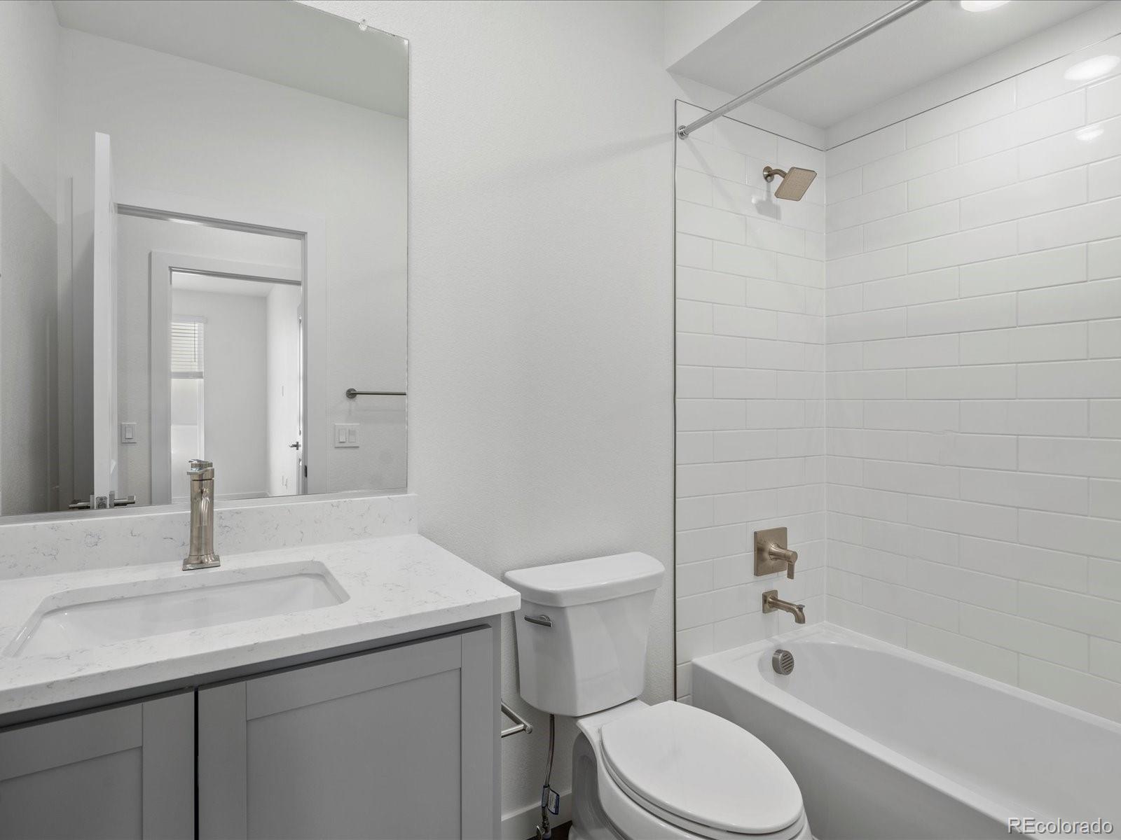 6153 North Ceylon Street, Unit 206 Denver, CO 80249 - Photo 18 of 25 a bathroom with a sink toilet and shower