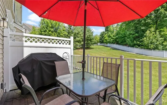 a view of balcony with chairs and wooden fence