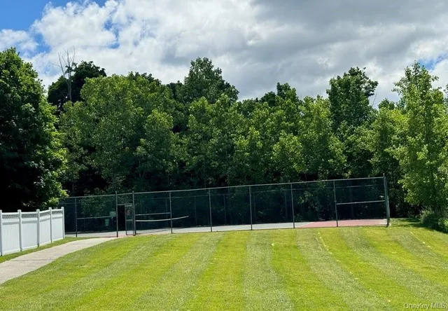 a view of a tennis court with a small yard
