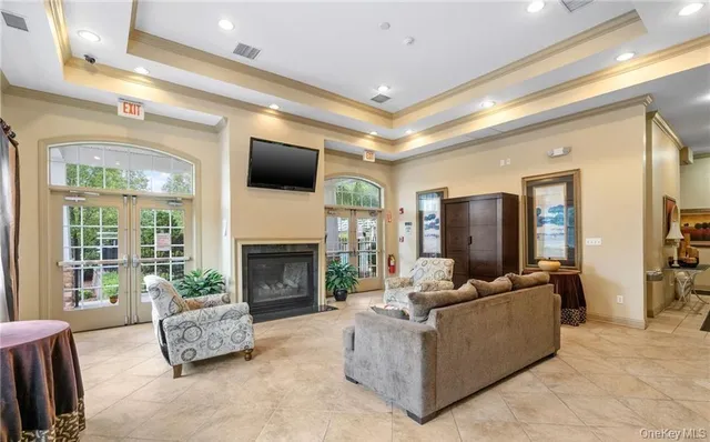 a living room with furniture a flat screen tv and a fireplace