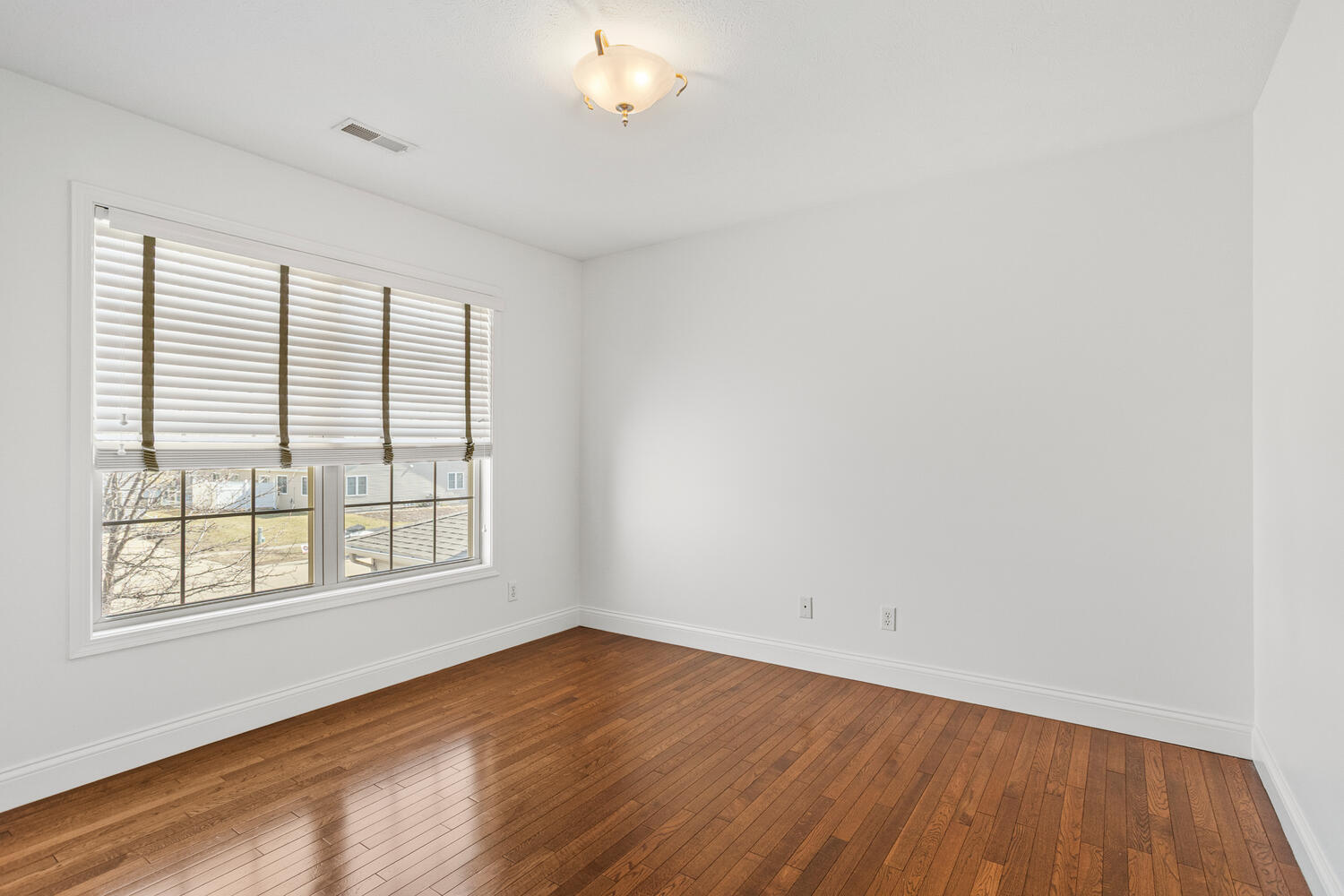 2517 Pembrook Point Champaign, IL 61821 - Photo 25 of 37 an empty room with wooden floor and windows