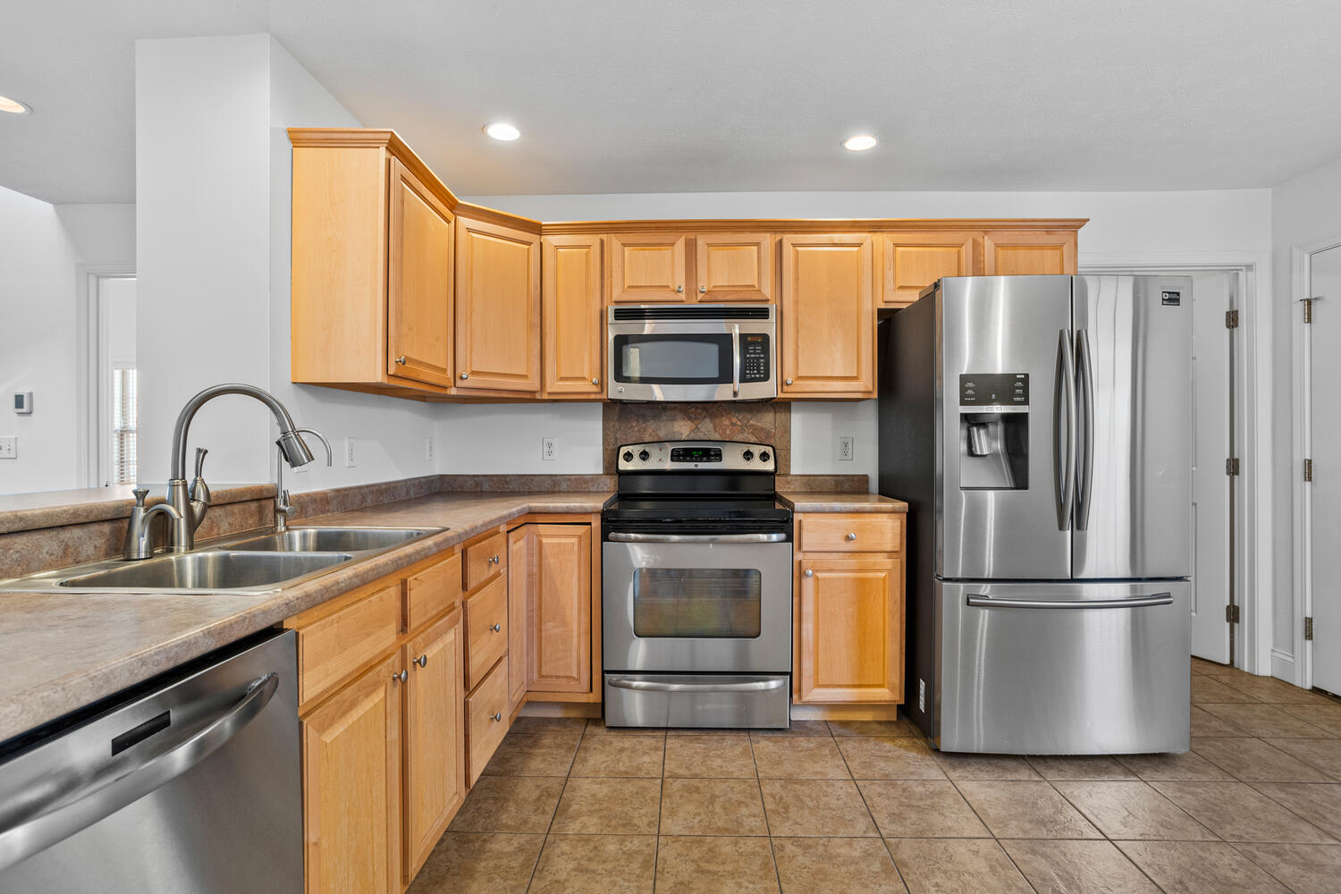 2517 Pembrook Point Champaign, IL 61821 - Photo 10 of 37 a kitchen with stainless steel appliances granite countertop a refrigerator sink and stove