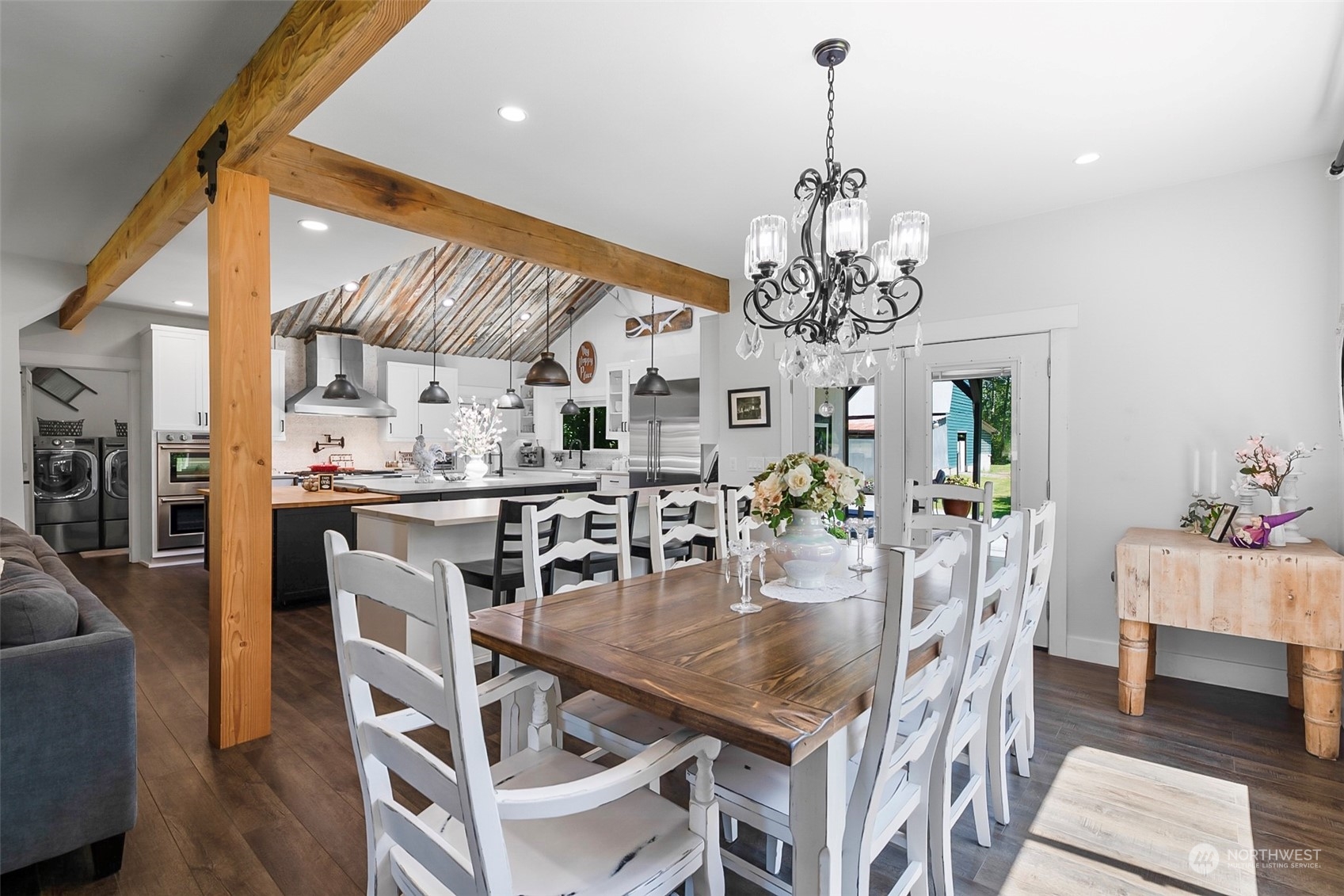19829 Niederle Road Monroe, WA 98272 - Photo 13 of 39 a view of a dining room with furniture a chandelier and wooden floor
