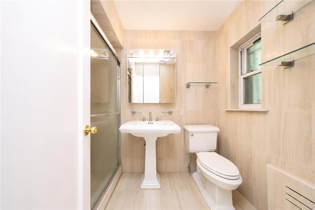 1 Bay Ridge Parkway Brooklyn, NY 11209 - Photo 17 of 38 a bathroom with a sink a toilet and shower