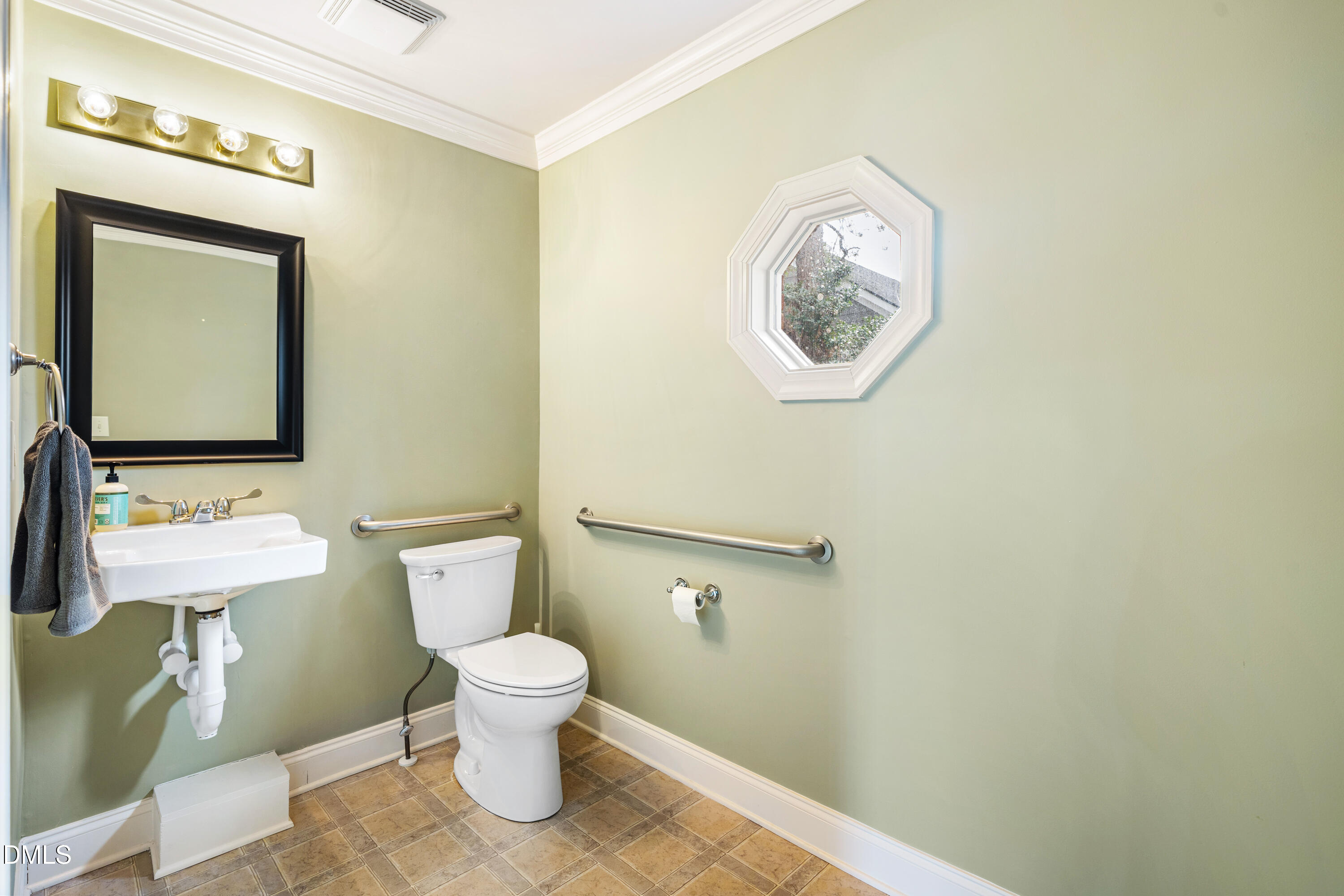130 Salem Towne Court Apex, NC 27502 - Photo 16 of 36 a bathroom with a toilet a sink and a mirror