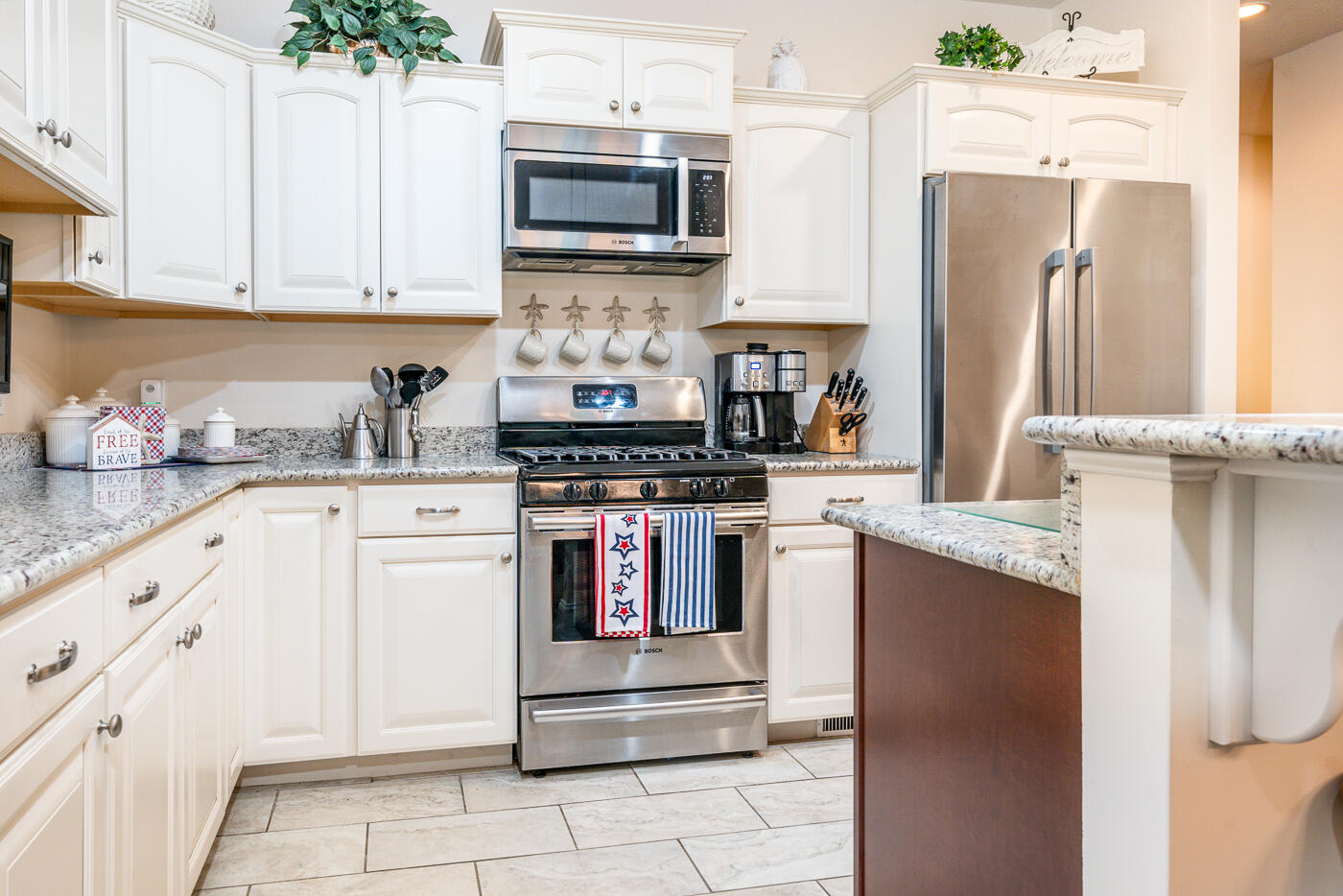 36 Southport Drive Mashpee, MA 02649 - Photo 4 of 21 a kitchen with stainless steel appliances kitchen island granite countertop a refrigerator and a stove top oven