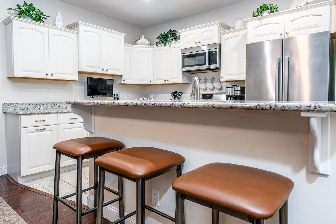 36 Southport Drive Mashpee, MA 02649 - Photo 5 of 21 a kitchen with stainless steel appliances kitchen island granite countertop a table chairs microwave and sink