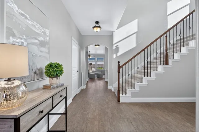 a view of entryway and hall with wooden floor