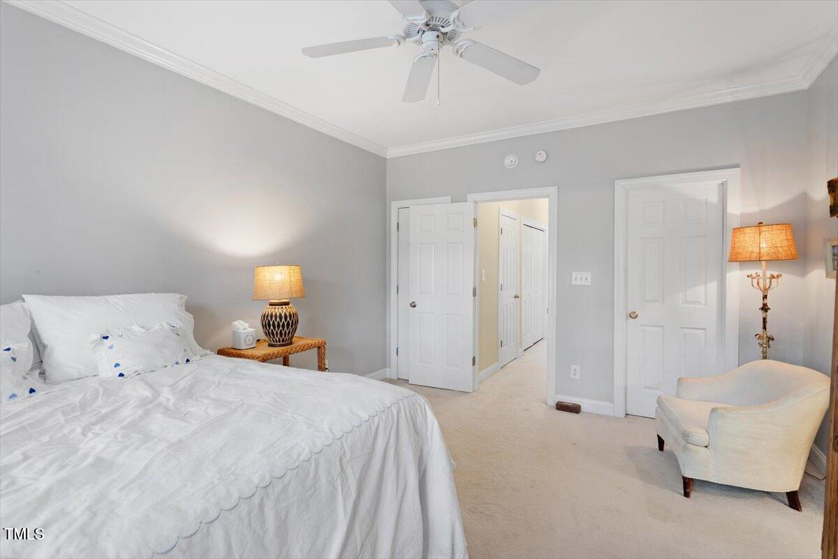 1307 Cameron View Court Raleigh, NC 27607 - Photo 18 of 26 a spacious bedroom with a bed and a chandelier