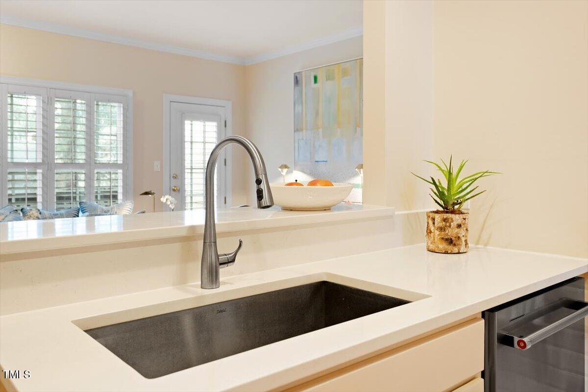 1307 Cameron View Court Raleigh, NC 27607 - Photo 8 of 26 a kitchen with a sink a counter and a potted plant