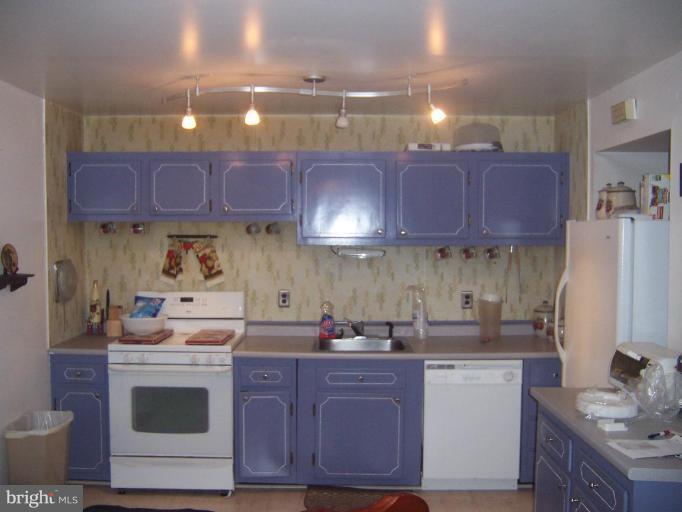 4775 Melbourne Road Baltimore, MD 21229 - Photo 2 of 8 a kitchen with stainless steel appliances granite countertop a sink stove and cabinets
