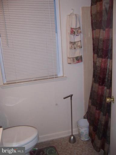 4775 Melbourne Road Baltimore, MD 21229 - Photo 3 of 8 a bathroom with a toilet and a shower