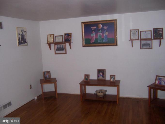4775 Melbourne Road Baltimore, MD 21229 - Photo 5 of 8 a living room with furniture and wooden floor