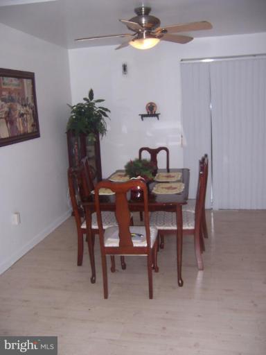 4775 Melbourne Road Baltimore, MD 21229 - Photo 8 of 8 a dining room with furniture and a chandelier fan