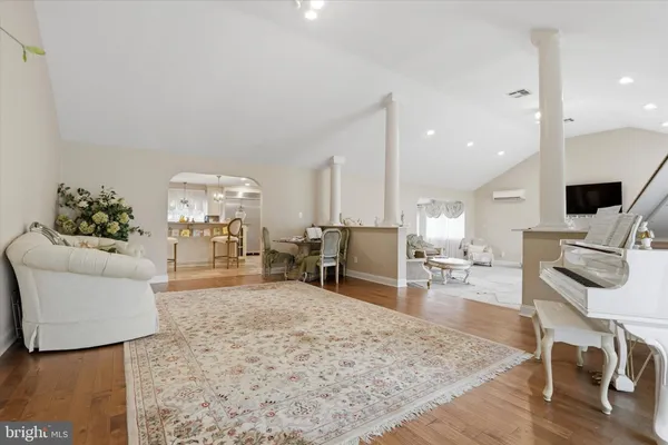 a living room with furniture and a wooden floor