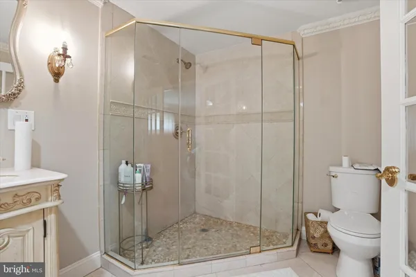 a bathroom with a double vanity sink a mirror and bathtub