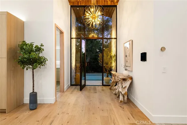 a kitchen with stainless steel appliances kitchen island granite countertop a table chairs sink and cabinets