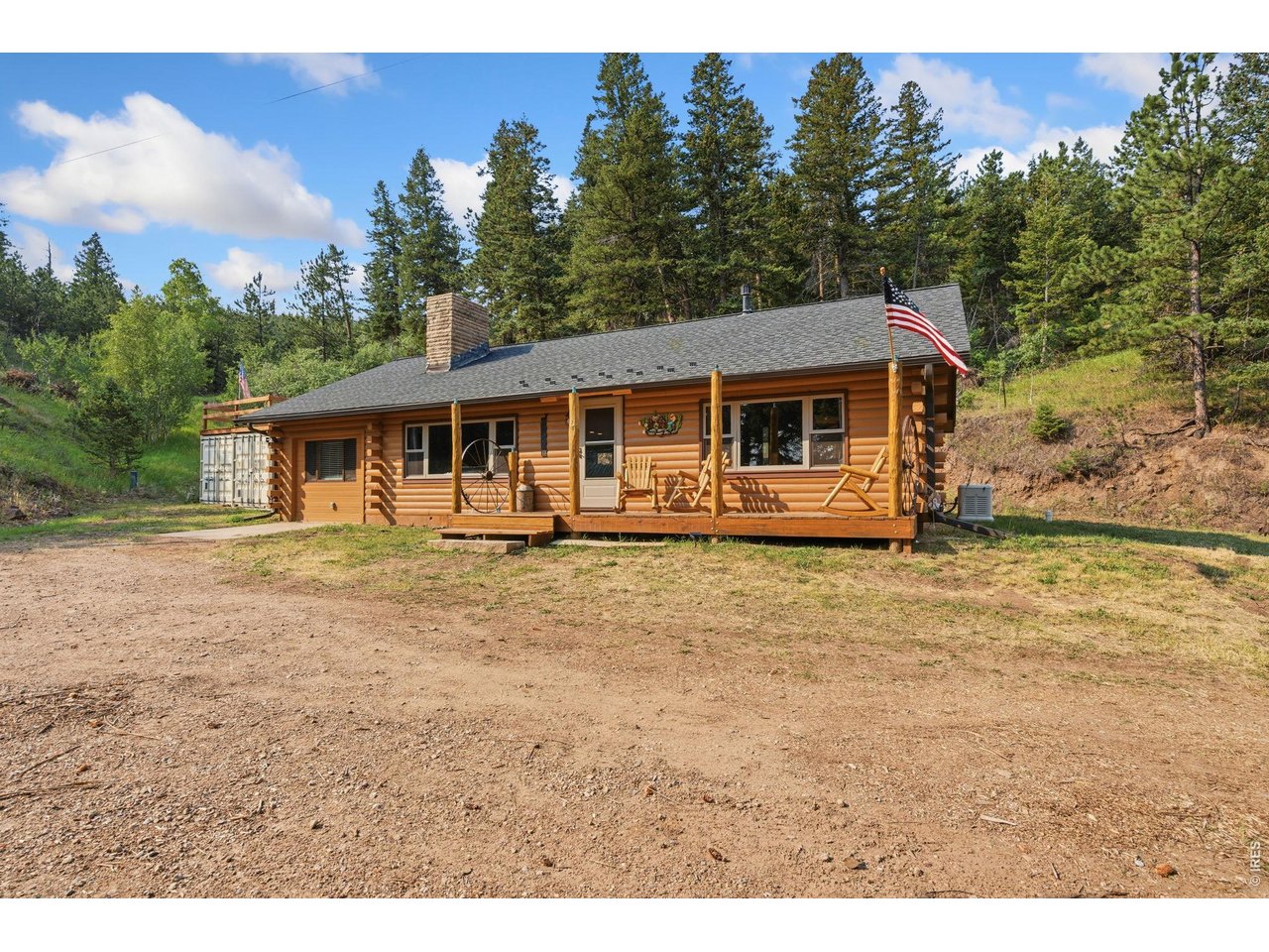 12743 Rist Canyon Road Bellvue, CO 80512 - Photo 4 of 49 a front view of a house with a yard