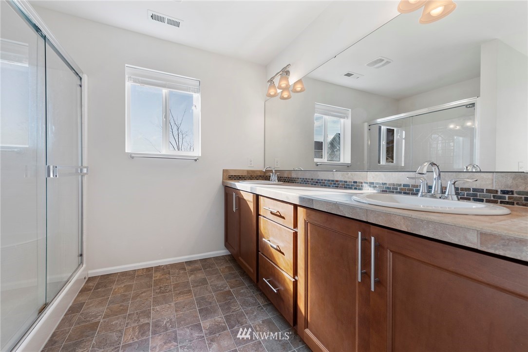 3910 177th Street Southeast Bothell, WA 98012 - Photo 14 of 27 a bathroom with a granite countertop sink and a mirror