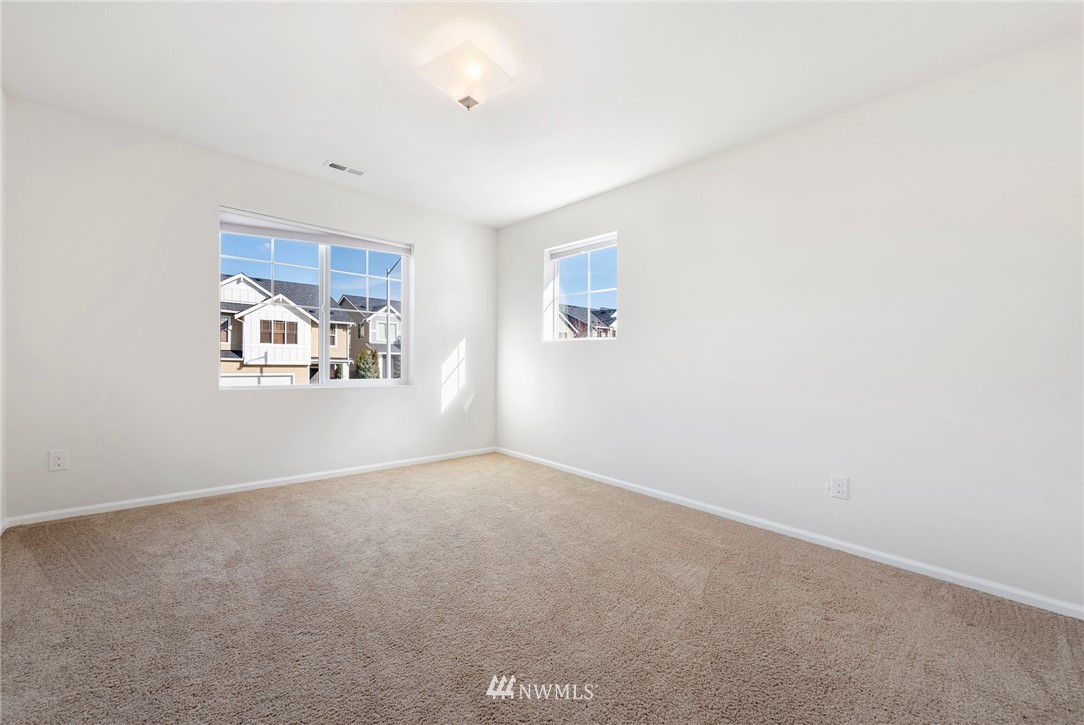 3910 177th Street Southeast Bothell, WA 98012 - Photo 17 of 27 an empty room with windows and a ceiling fan