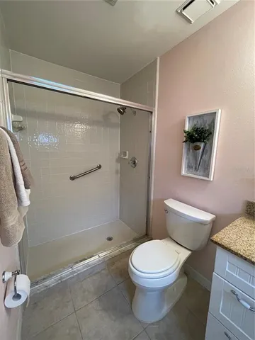 a bathroom with a toilet and a shower