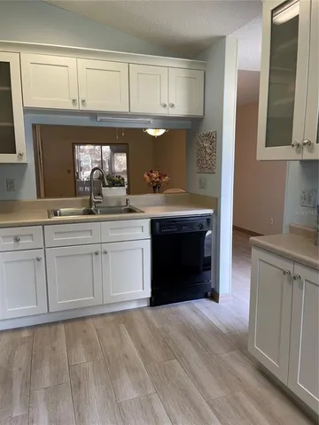 a kitchen with granite countertop a sink and cabinets