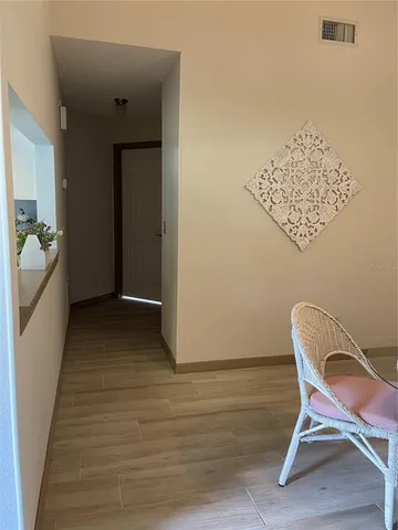 a view of a room with furniture and wooden floor