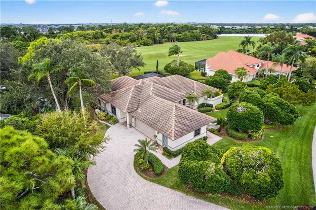 an aerial view of a house with garden space and a street view