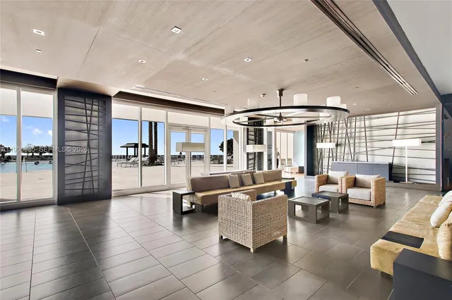 a living room with furniture and kitchen view