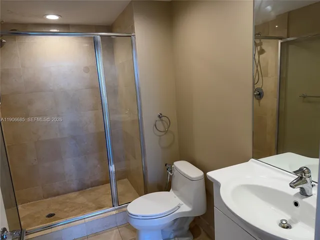 a bathroom with a shower and a toilet