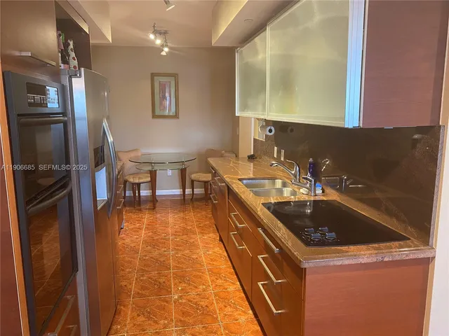 a bathroom with a granite countertop sink mirror and a bathtub