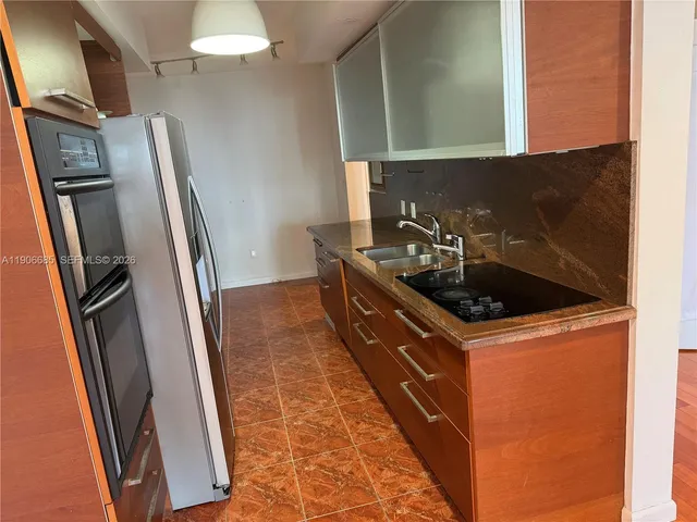 a kitchen with sink a refrigerator and washer