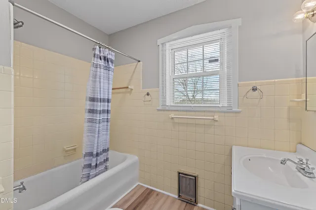 a bathroom with a bathtub and shower